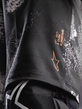 A-Dura Ride Shorts in Black Camo, featuring an orange Alpinestars logo on durable 4-way stretch woven fabric for MTB.