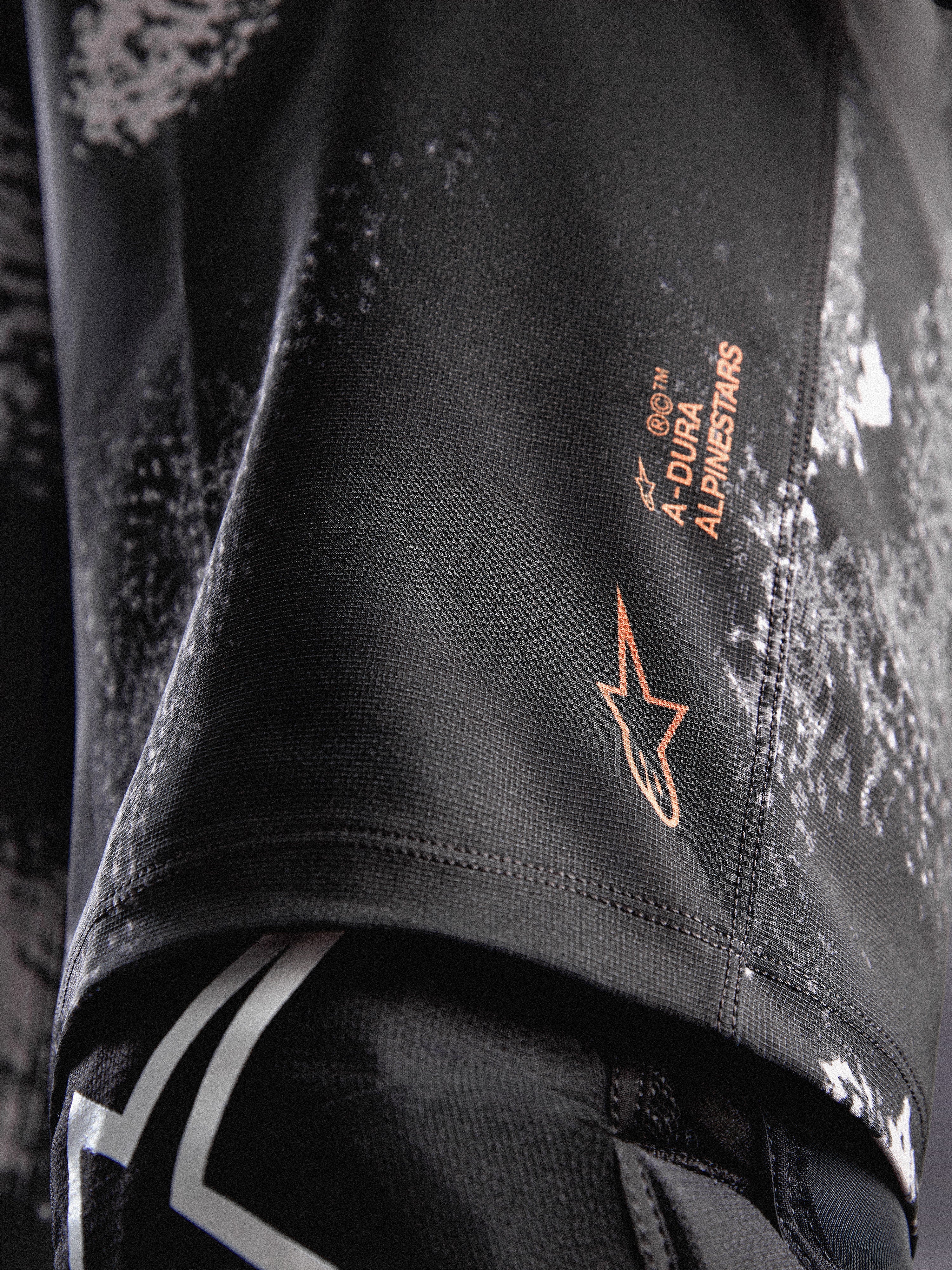 Alpinestars A-Dura Ride Calções em Black Camo, com logótipo laranja e tecido elástico resistente para MTB