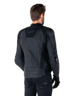 Alpinestars Missile V3 Leather Jacket, Black, rear view on model, premium racing sport jacket with leather construction, featuring embossed Alpinestars branding on the lower back and TPU elbow sliders.