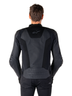 Rear view of a model wearing the Alpinestars Missile V3 Airflow Leather Jacket in Black, showing extensive perforated panels and mesh inserts on the back for ventilation, with embossed branding on the lower back.