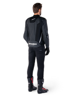 Alpinestars Missile V3 Airflow Leather Jacket, Black and White, rear view worn with black technical pants and racing boots, featuring perforated leather back panels and bold Alpinestars branding on the lower back.