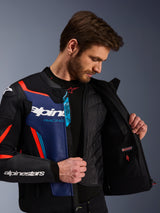 Alpinestars GP Force V2 Leather Jacket in Black Blue and Red Fluo, close-up view showing the internal detachable thermal vest and waterproof pocket, premium bovine leather with Tech-Air Ready branding, sport-optimized motorcycle apparel.