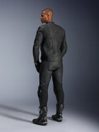Alpinestars Missile V3 Leather Pants and Dusk Leather Jacket, Black with gold accents, rear view of rider, featuring embossed branding and accordion stretch panels, worn with black Supertech R boots and gloves, professional motorsport apparel.