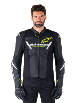 Alpinestars Faster V3 Airflow Leather Jacket, Black White and Yellow Fluo, worn by a male model with matching black gloves, featuring perforated leather panels for ventilation and bold Alpinestars branding on the chest, sport motorcycle riding gear