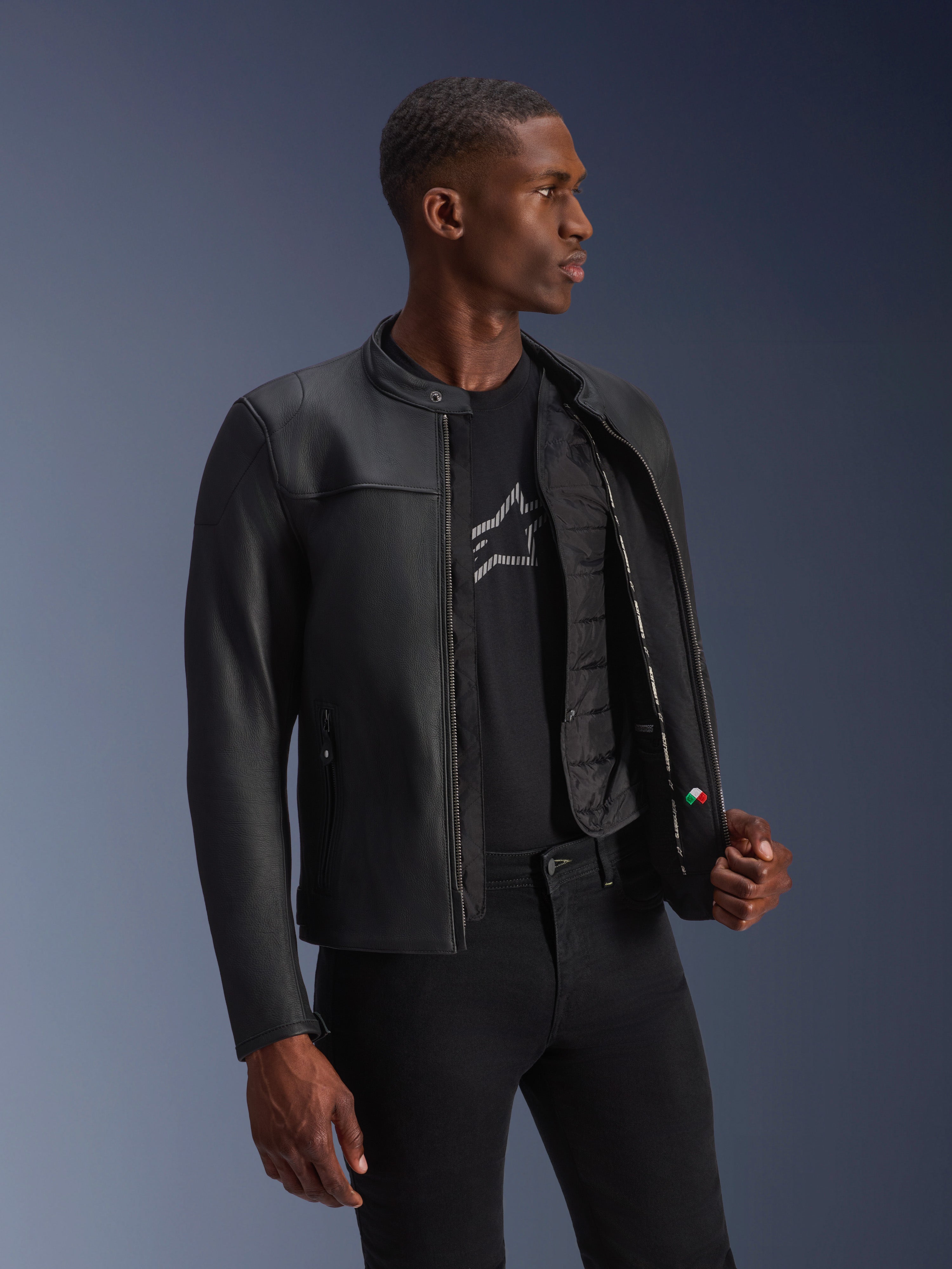 Alpinestars Blacktrack Leather Jacket, Black, premium bovine leather with a tailored fit, unzipped showing the detachable thermal vest and interior details, worn by a model, modern urban motorcycle gear