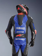 Fato de Couro Alpinestars Yamaha GP-R7 (1 Peça), vista traseira, azul metálico e preto com pormenores em branco e vermelho, logótipos Yamaha e GYTR em destaque, com corcunda aerodinâmica, usado com capacete e luvas de competição a condizer para um visual profissional pronto para a pista
