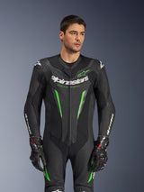 Alpinestars GP Force V2 Leather Suit - 1 Peça, fato de competição de motociclismo em preto e verde, vestido por modelo, apresentando painéis de pele perfurada, logótipo Alpinestars branco em destaque no peito e mangas, e proteção de ombros integrada para desempenho em pista.