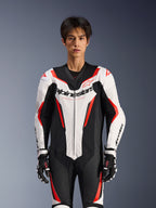 Alpinestars GP Force V2 Leather Suit - 1Piece, White Black and Red Fluo, worn by a male model, featuring perforated leather panels and bold Alpinestars branding on the chest, coordinated with black and white racing gloves, designed for track and performance riding