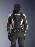 Rear view of the Alpinestars Stella GP-R7 2-Piece Leather Suit in Black White and Red Fluo, featuring an aerodynamic race hump with GP-R7 branding, perforated leather panels, accordion stretch zones, and Tech-Air® Ready logo on the lower back.