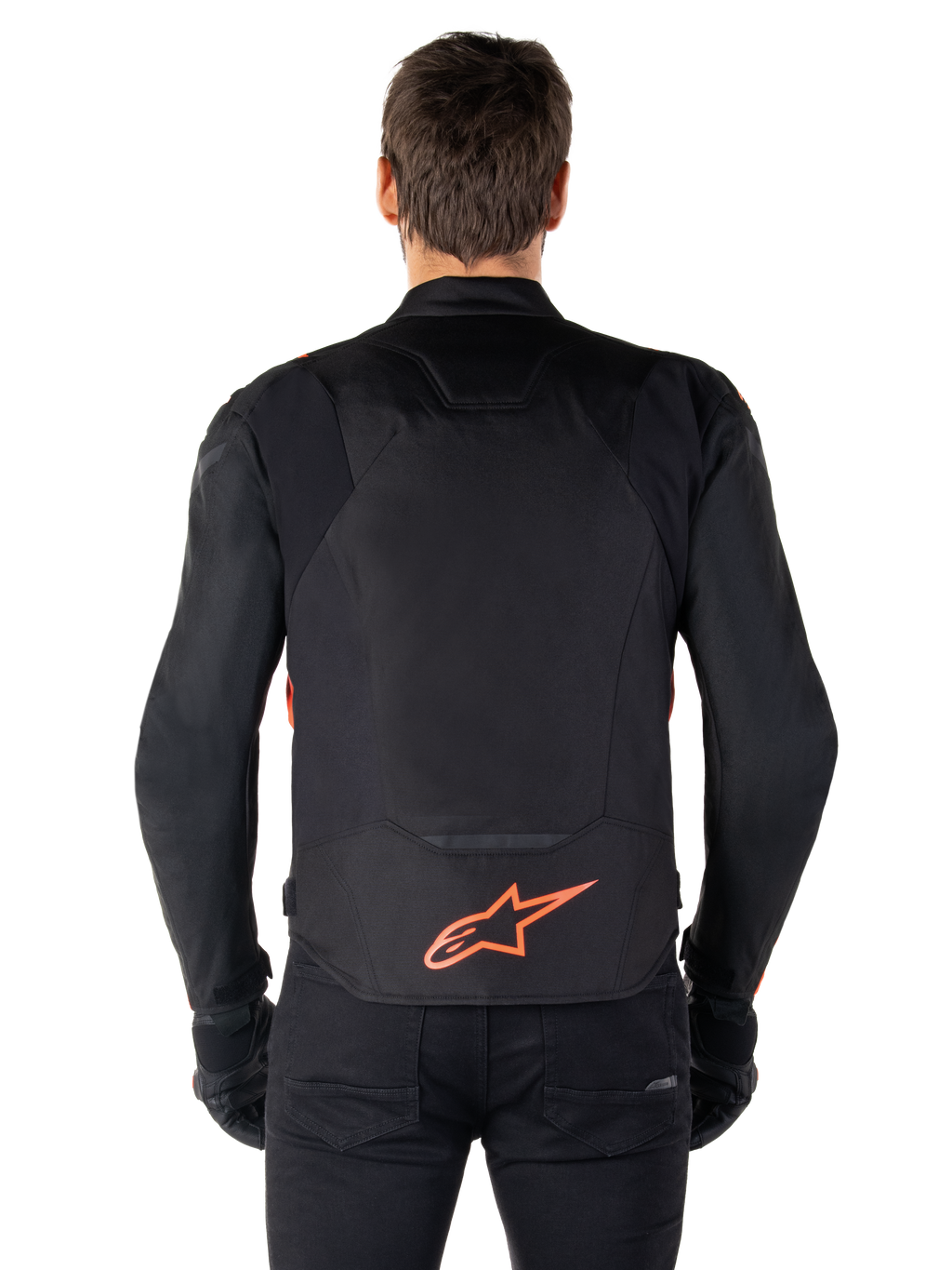 Casaco Alpinestars T-Jaws V4 Waterproof, vista traseira, preto com vermelho fluo, com um logótipo Alpinestars vermelho na parte inferior das costas, construção em tecido técnico, usado com calças e luvas pretas para um visual de condução desportivo completo