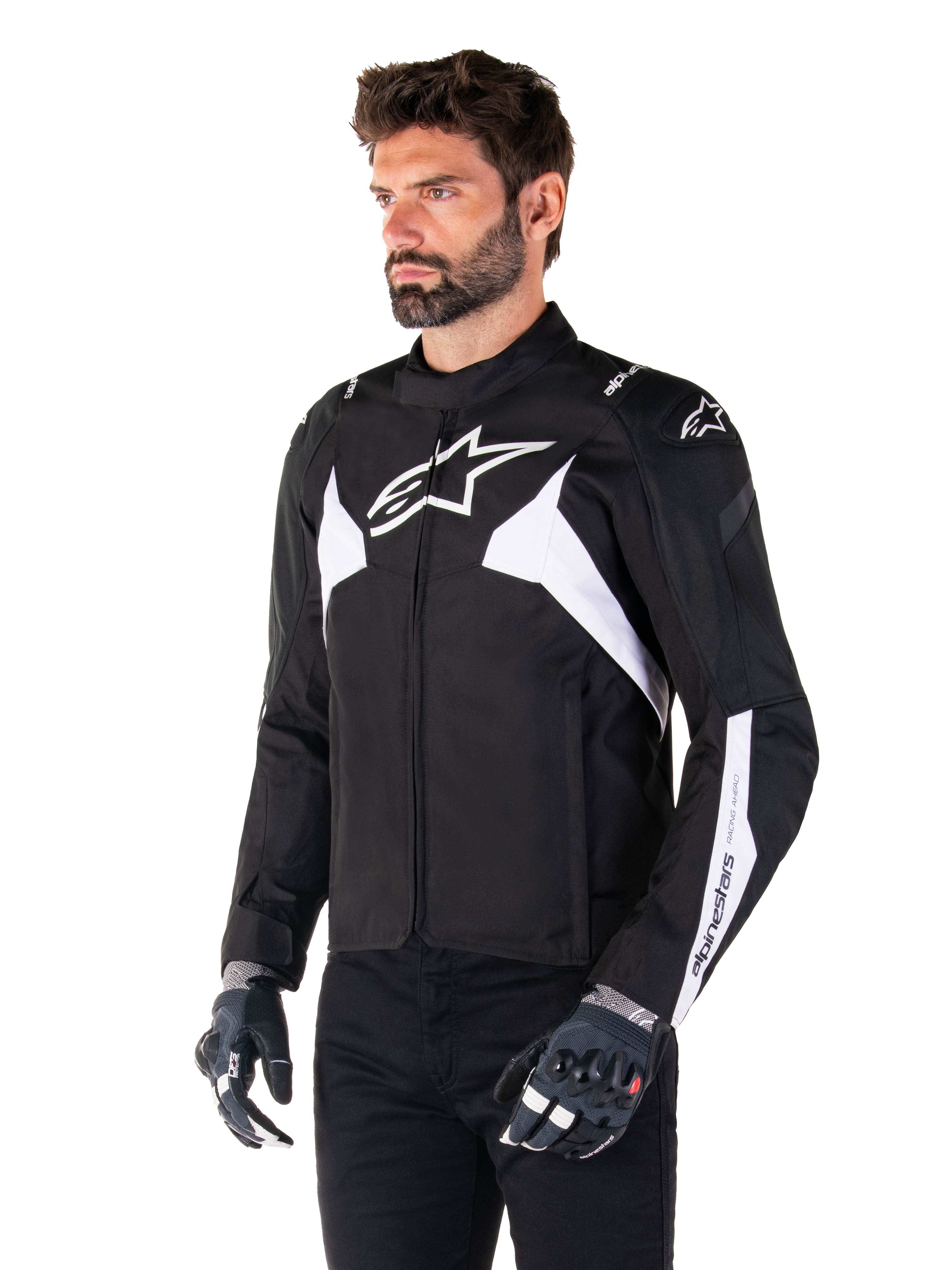 Alpinestars T-Jaws V4 Waterproof Jacket, Black and White, worn by a model with motorcycle gloves, featuring prominent white Alpinestars logos and accents, sport-fit textile motorcycle jacket for road riding