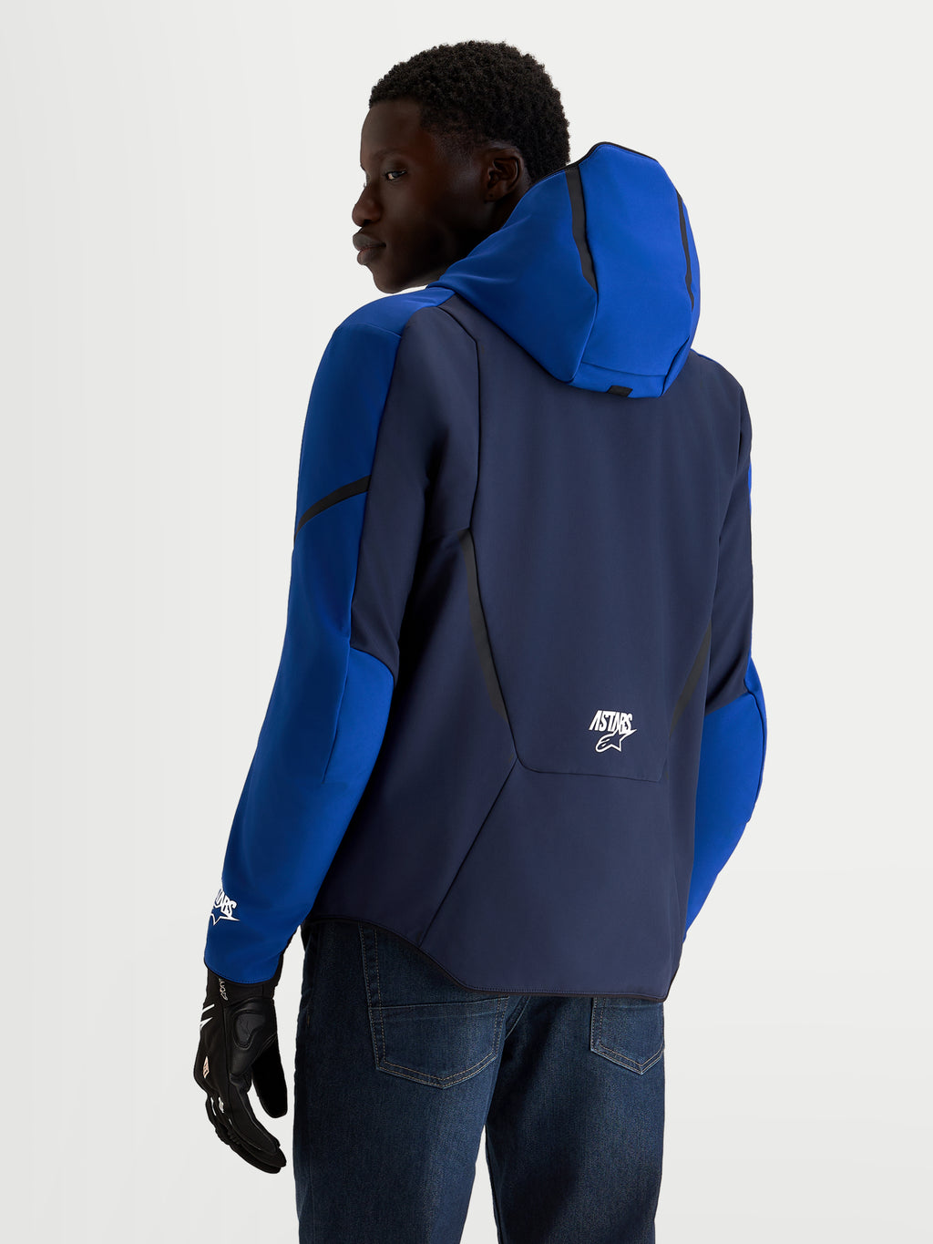 Alpinestars Aeroshell Waterproof Jacket, Men's Night Navy and Bright Blue motorcycle sports softshell jacket with open-slot hood and CE-certified protection, rear view on model wearing riding gloves