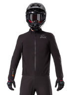 Alpinestars AMT-8 Stretch Drystar® XF Liner, forro de motociclismo impermeável preto, com fecho de correr frontal e cintura elástica, logótipo AMT no peito e marca Drystar XF na manga, usado com capacete e luvas pretas.