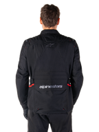 Alpinestars ST-1 Waterproof Jacket, Black, Back View, adventure touring motorcycle jacket featuring red accents on the waist, Alpinestars logo on the upper back, and wordmark on the lower back flap