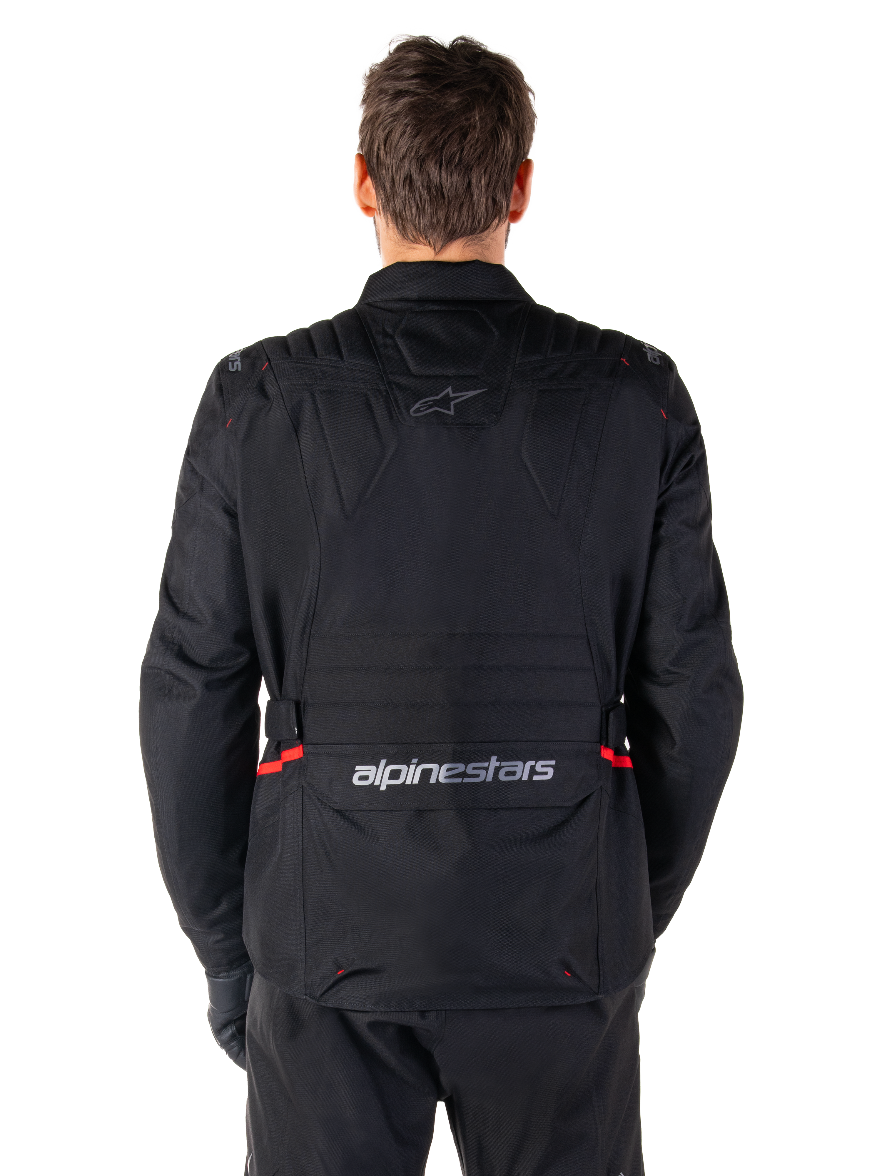 Alpinestars ST-1 Waterproof Jacket, Black, Back View, adventure touring motorcycle jacket featuring red accents on the waist, Alpinestars logo on the upper back, and wordmark on the lower back flap