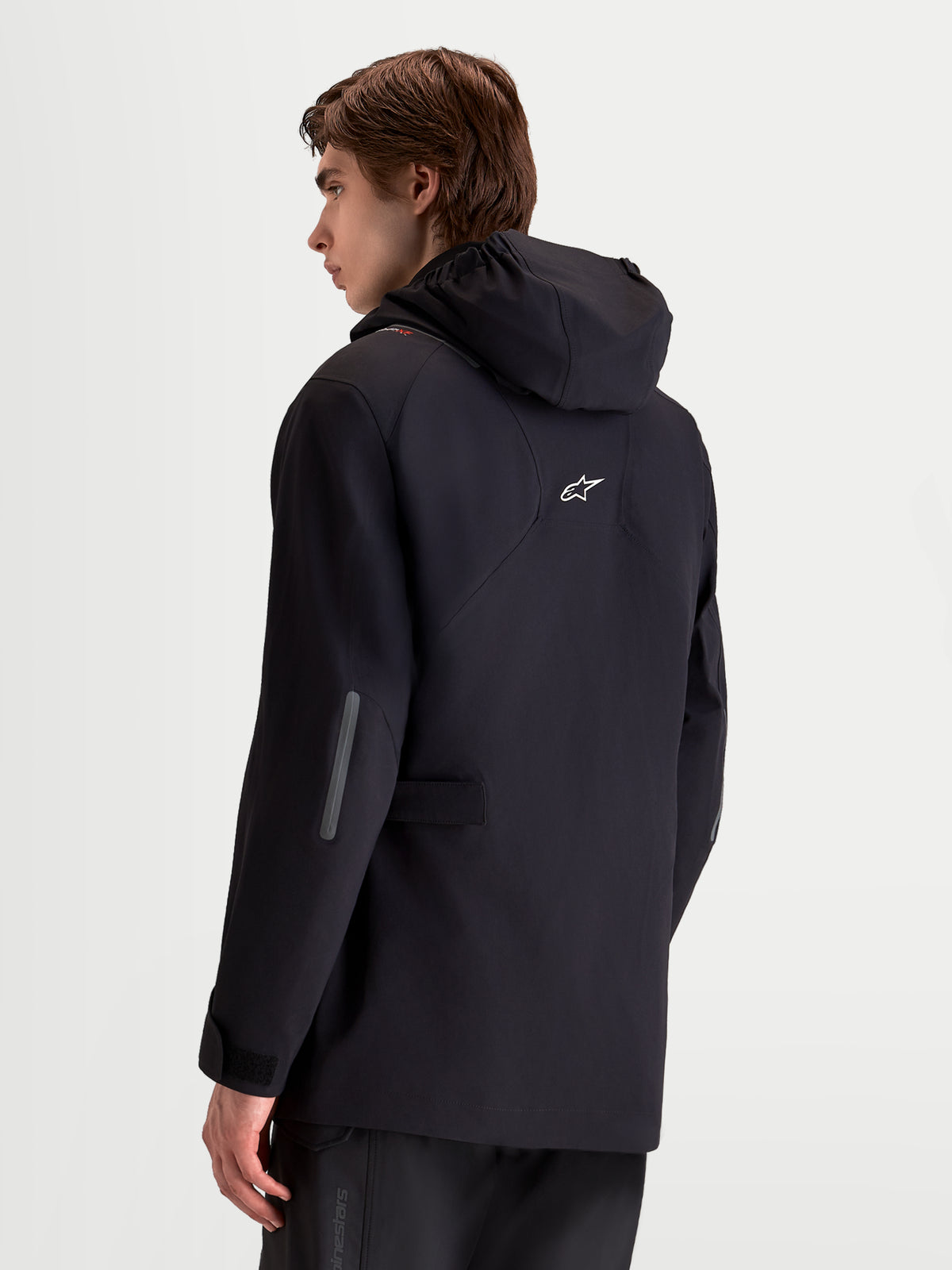 Alpinestars C-7 Drystar®XF Jacket, men's urban contemporary motorcycle textile jacket in black, rear three-quarter view on a model showing integrated hood and reflective details