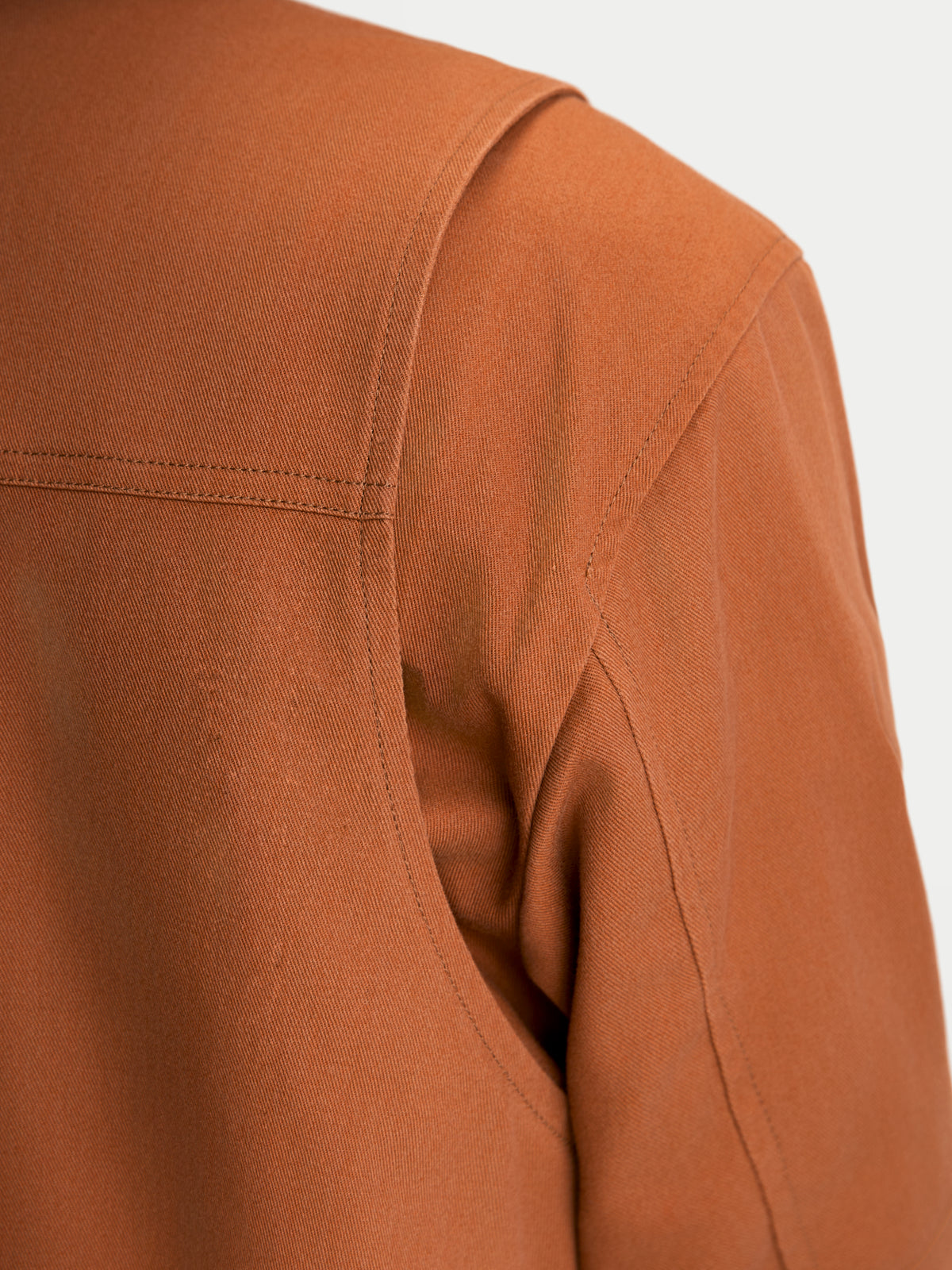 Alpinestars Mustang Waterproof Jacket, men's urban textile motorcycle jacket in dark rust, close-up view of the shoulder gusset and stretch twill construction