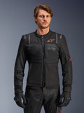 Alpinestars ST-2 Air Jacket, Black Men's Textile Riding Jacket, features large mesh panels, red Alpinestars logo, and "ALPINESTARS EXPLORATION EQUIPMENT" branding on the chest, worn by a male model with black gloves and pants