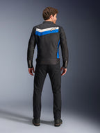 Alpinestars T-Dyno WR Jacket, textile motorcycle jacket, Black Blue Ecru colorway, full back view on model, featuring a blue and off-white chevron stripe with Alpinestars logo, paired with black pants and boots, vintage-inspired urban riding gear