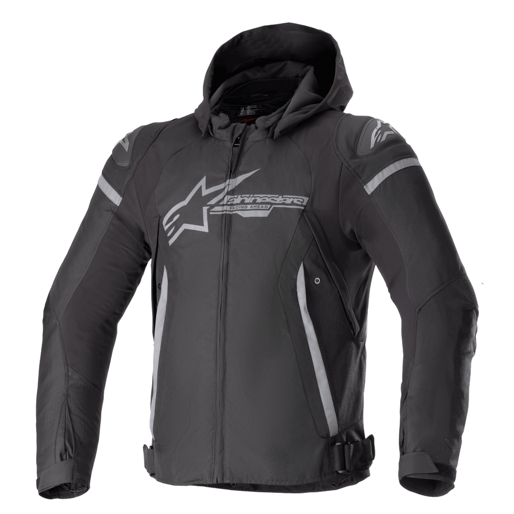 Alpinestars Zaca Waterproof Jacket, Motorcycle Sport Jacket, Black and Dark Gray, featuring a detachable hood, large gray chest logo, light gray accents on shoulders and sides, adjustable waist straps, and front zipper closure, sporty textile construction