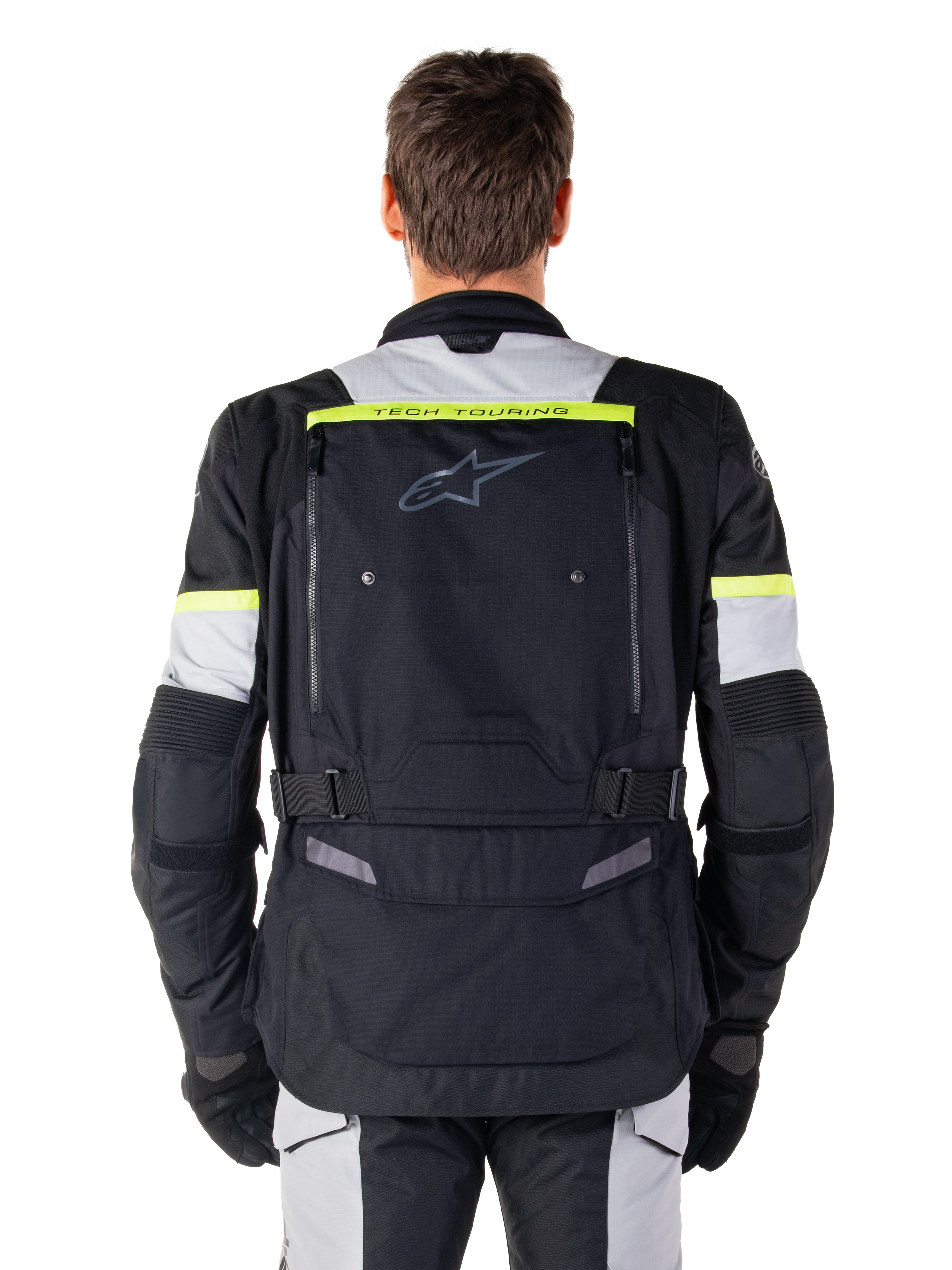 Alpinestars Bogota' Pro Drystar® Jacket, casaco de motociclismo adventure touring, preto, cinzento e amarelo néon, vista traseira mostrando a marca 'TECH TOURING' numa faixa amarela fluorescente, grande painel de ventilação traseiro e tiras de ajuste na cintura, equipamento técnico para todas as estações