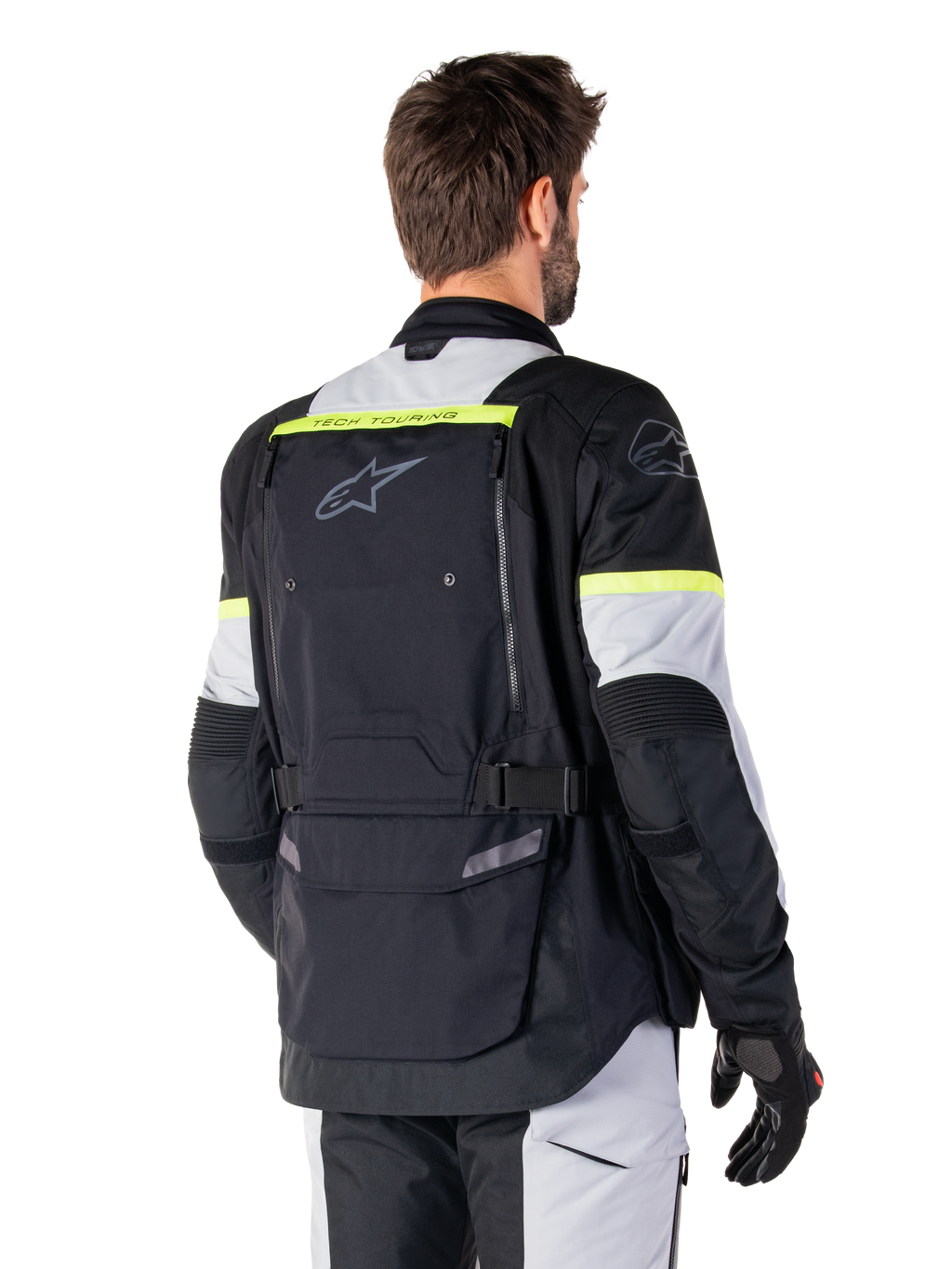 Casaco Alpinestars Bogotá Pro Drystar®, casaco de adventure touring, Preto, Ice Gray e Amarelo Fluo, vista traseira com grande painel de bolso traseiro e marca 'TECH TOURING', logótipo Alpinestars e detalhes fluorescentes, equipamento de condução em têxtil técnico