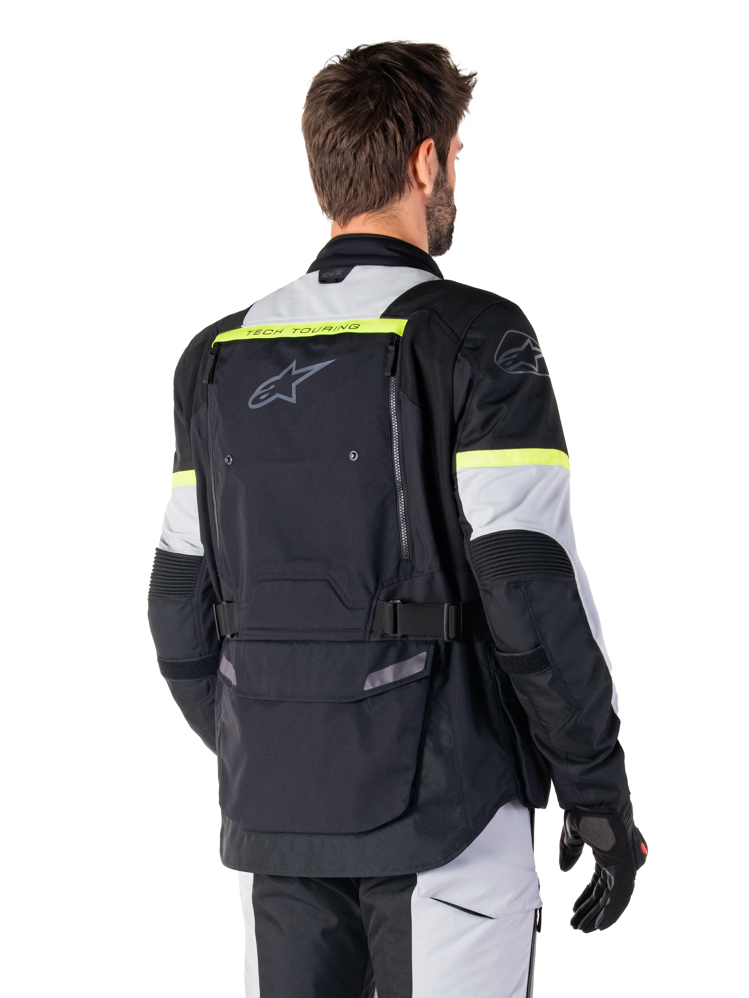 Casaco Alpinestars Bogotá Pro Drystar®, casaco de adventure touring, Preto, Ice Gray e Amarelo Fluo, vista traseira com grande painel de bolso traseiro e marca 'TECH TOURING', logótipo Alpinestars e detalhes fluorescentes, equipamento de condução em têxtil técnico