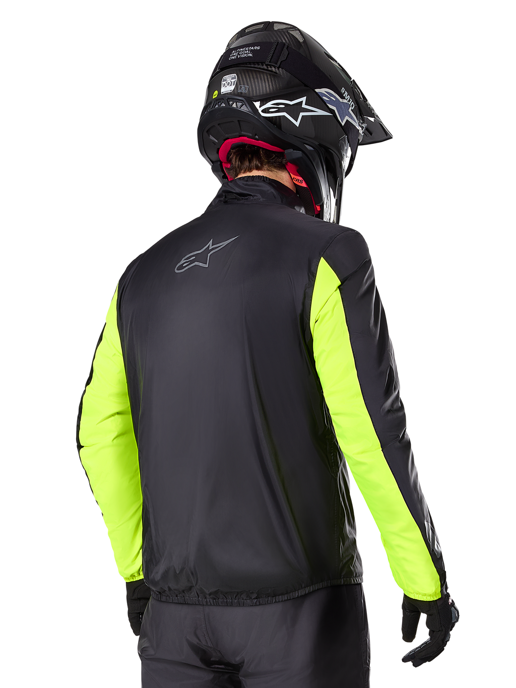 Casaco Alpinestars Bogotá Pro Drystar®, vista traseira, preto com mangas amarelo fluo, usado por um motociclista com capacete e luvas pretas, equipamento de motociclismo adventure touring de alta visibilidade com acabamento têxtil técnico.