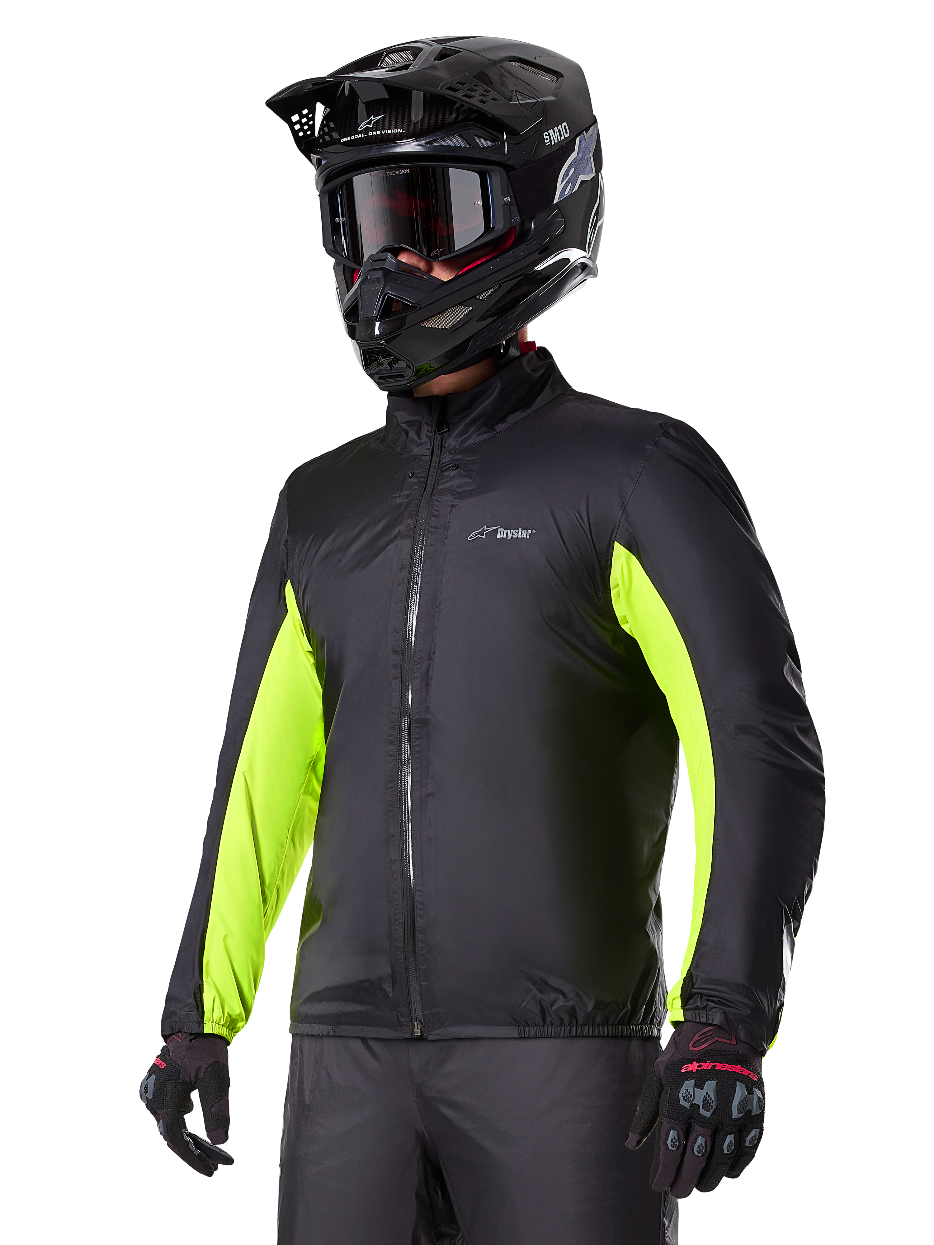 Forro impermeável do casaco Alpinestars Bogotá Pro Drystar®, preto com detalhes em amarelo néon nas mangas, usado por um condutor com capacete preto e óculos de proteção, vestuário técnico de motociclismo