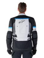 Alpinestars Bogota' Pro Drystar® Jacket, Adventure Motorcycle Jacket, Ice Gray Black and Cyan, back view featuring a large light gray panel with black star logo, cyan accents with Tech Touring branding, and adjustable waist straps