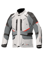 Casaco Alpinestars Andes V3 Drystar, casaco de motociclismo adventure touring, cinzento gelo e cinzento escuro com detalhes vermelhos, construção têxtil impermeável com correias de ajuste e aberturas de ventilação com fecho, design de gola alta para proteção em todas as condições meteorológicas