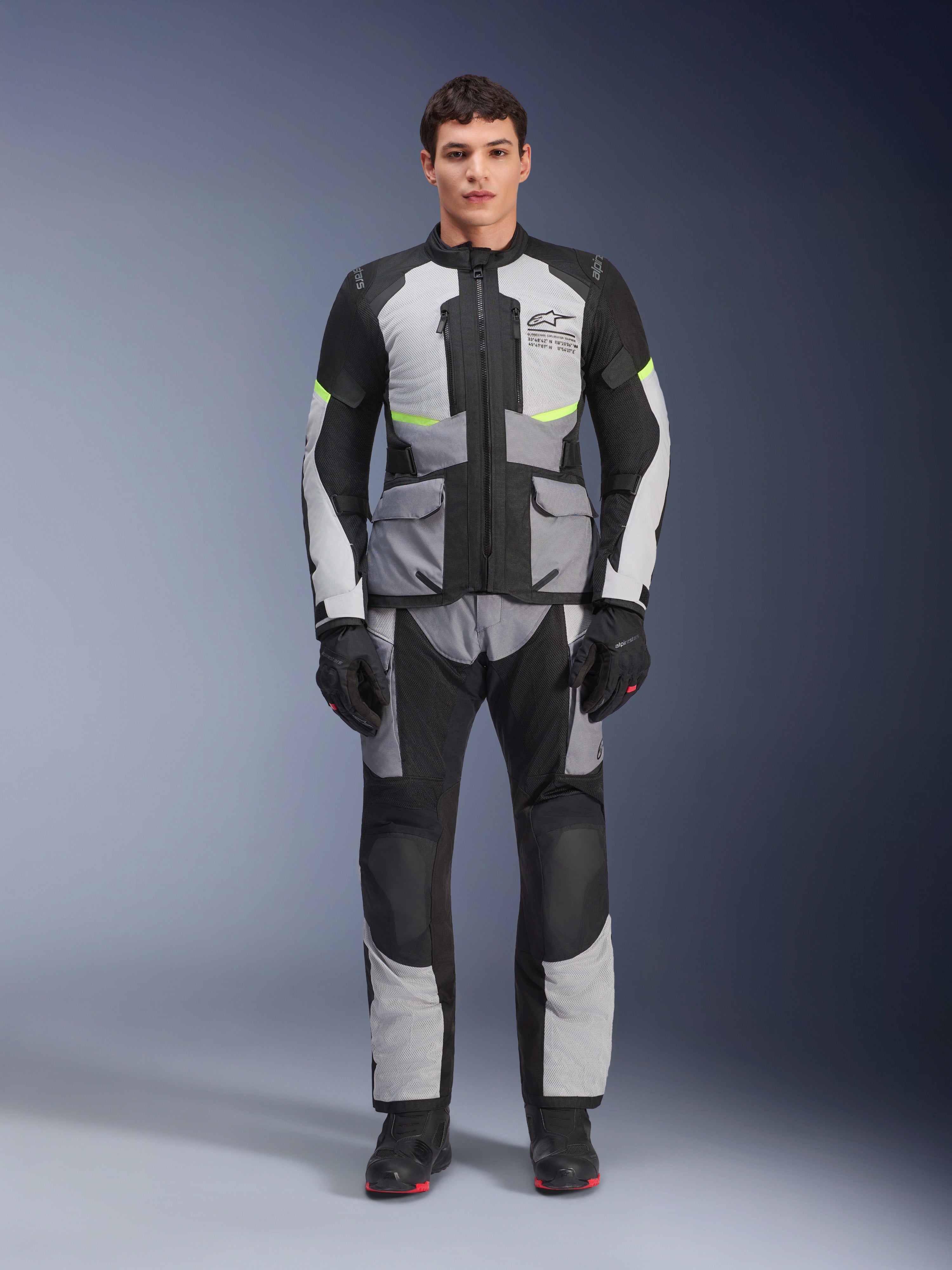 Alpinestars Andes Air Drystar® Pants, Adventure Touring Motorcycle Pants, Ice Gray and Black with neon yellow accents, full-body view on a model wearing the matching jacket and gloves, textile design with mesh ventilation panels