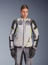 Alpinestars Woman Stella Andes V4 Drystar® Jacket, Ice Gray and Dark Gray with Yellow Fluo accents, adventure touring motorcycle jacket, worn with matching pants and gloves, featuring protective textile construction and Alpinestars branding.
