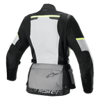 Alpinestars Stella Andes Air Drystar® Jacket, casaco de turismo de motociclismo para mulher, vista traseira, cinzento gelo, cinzento escuro e preto, com um grande painel traseiro em malha branca, bolsa de armazenamento traseira cinzenta com logótipo, detalhes em amarelo de alta visibilidade e construção em têxtil para fluxo de ar e proteção.