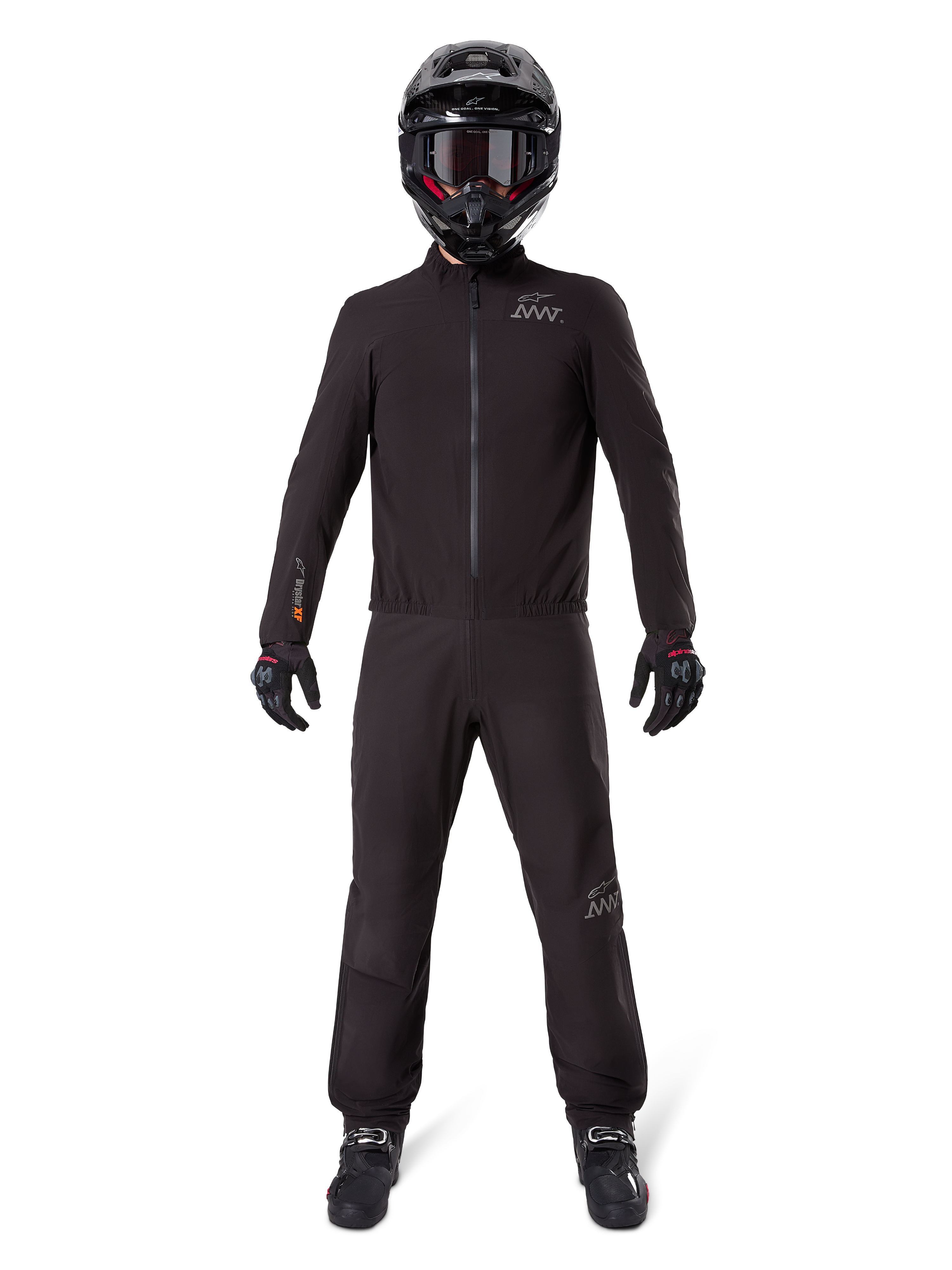 Motorcycle rider wearing Alpinestars AMT-8 Stretch Drystar® XF Pant Liner and matching jacket, all-black waterproof and windproof technical gear, featuring a black helmet, gloves, and boots, sleek adventure touring design.