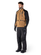 Calças Alpinestars Hyde XT Drystar®, calças de motociclismo de aventura, pretas, usadas com um casaco técnico castanho e preto, luvas e botas pretas, com um design por cima da bota para condução off-road e dual-sport