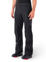 Alpinestars ST-1 Waterproof Pants, Black Motorcycle Touring Pants, worn with black and red riding boots, featuring zippered front pockets and a subtle star logo on the thigh, ergonomic design for adventure and road riding.