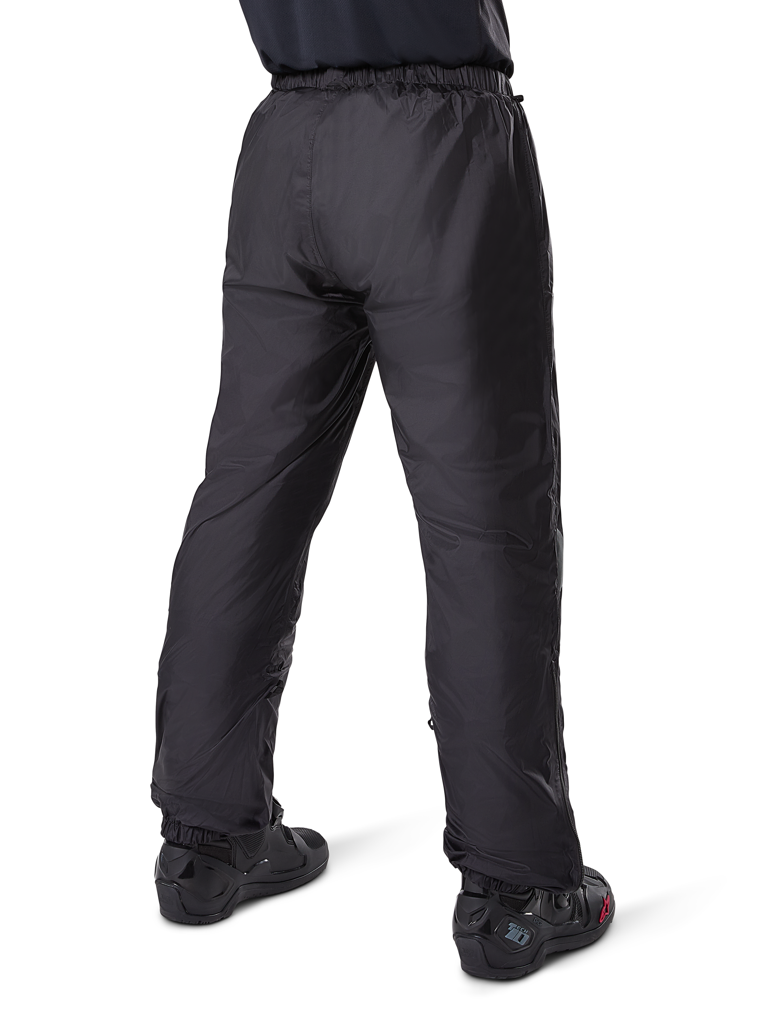 Alpinestars Bogota' Pro Drystar® 3 Seasons Pants, Black adventure touring motorcycle pants, rear view of the waterproof Drystar® liner worn as over-pants, paired with black motorcycle boots, technical lightweight construction for multi-season weather protection