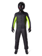 Alpinestars Bogota Pro Drystar 3 Seasons Pants, Black, worn by a motorcycle rider in a full adventure outfit including a black and neon yellow waterproof jacket, black helmet, and riding boots, designed for all-weather touring performance.