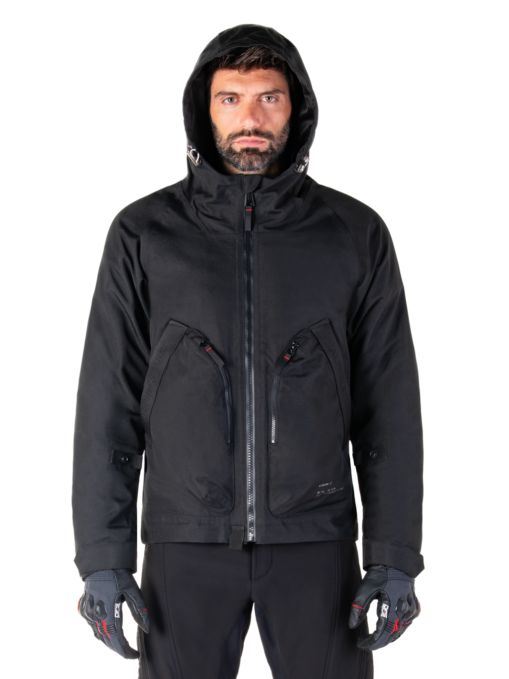 Alpinestars Morush Waterproof Parka, Black, Urban motorcycle jacket with a hood and large front utility pockets, worn by a model with protective riding gloves, minimalist and contemporary streetwear-inspired design.