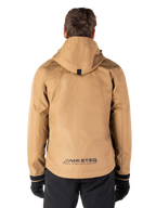 Alpinestars Morush Waterproof Parka, Utility Brown, rear view, featuring a hood and MO.ST.EQ. branding on the lower back, paired with black pants and gloves, modern streetwear-inspired motorcycle gear