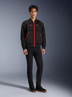 Alpinestars Flight Air Jacket in Black Bright Red, bomber-style urban motorcycle jacket featuring 3D mesh panels and vibrant red zippers, worn by a model with black slim-fit pants and black sneakers, street-inspired contemporary riding gear