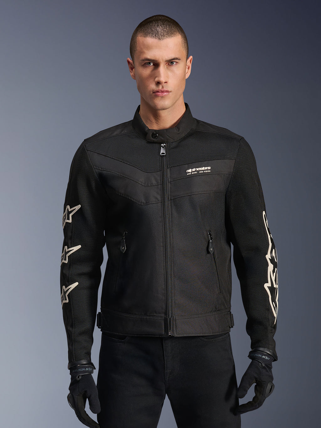 Alpinestars T-Dyno Air Jacket, Black textile motorcycle jacket, featuring white star graphics on sleeves and logo on chest, mesh panels for ventilation, vintage-inspired biker fit, worn with black gloves and pants