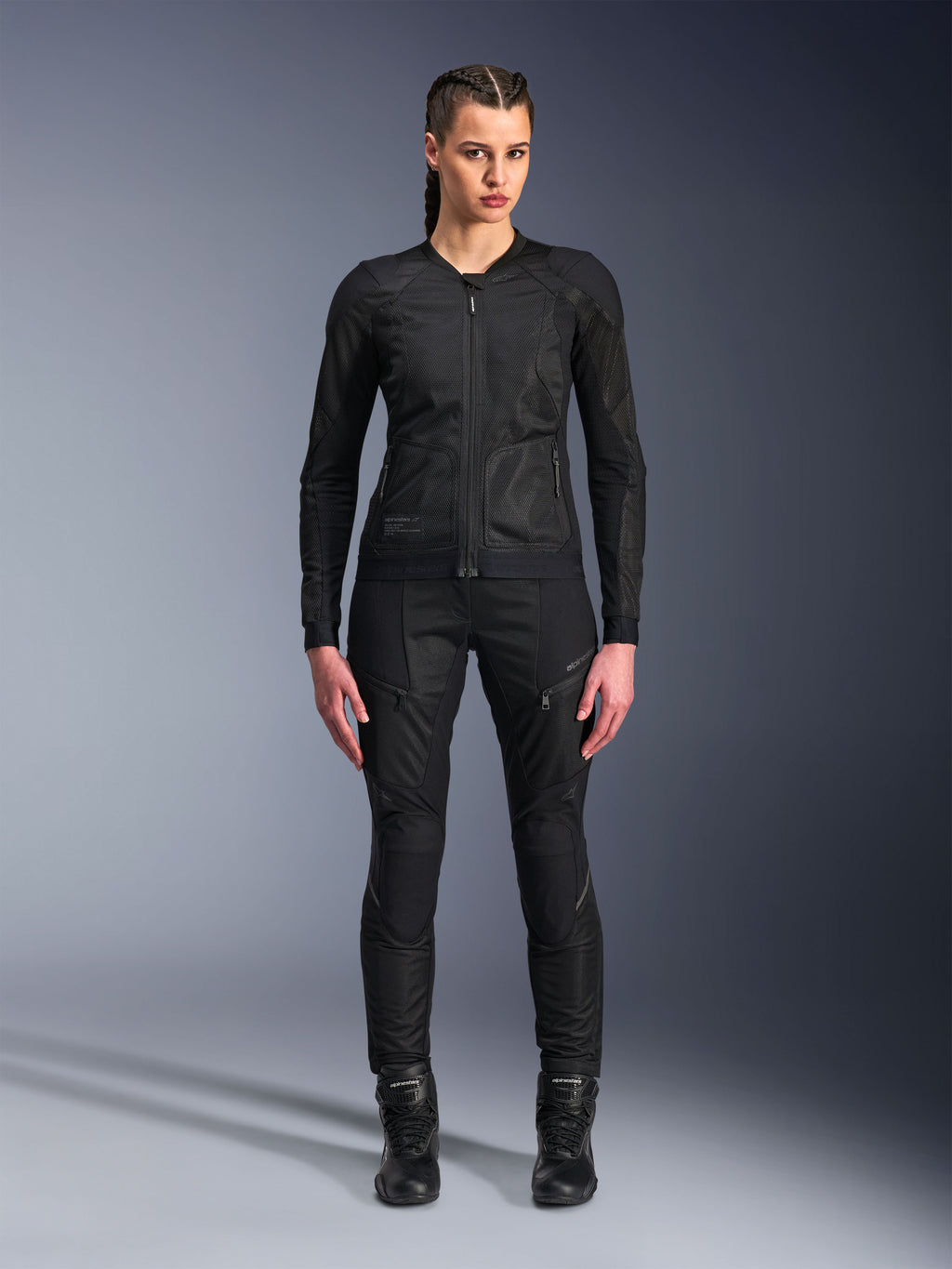Alpinestars Stella Troop-Air Jacket, Women's Motorcycle Jacket, Black, technical 2D mesh construction with a minimalist design, worn with black riding pants and boots, contemporary urban motorcycling style.