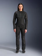 Woman wearing Alpinestars Stella C-1 Air Jacket in Black, paired with matching black textile motorcycle pants and riding shoes, featuring a sleek urban design with large mesh panels for airflow.