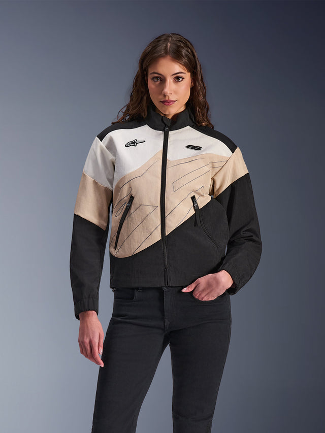 Alpinestars Stella Moshell Jacket, women's urban motorcycle jacket, asymmetrical color-blocked design in Black, Sand, and Off White, featuring front zipper and zippered hand pockets, modeled with black pants for a contemporary streetwear look.