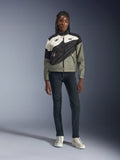 Alpinestars Stella Moshell Jacket, Women's Motorcycle Jacket, Black, Fur Gray, and Off White with Pink accents, worn by a model with dark jeans and off-white sneakers, featuring an asymmetrical zip-up design with bold geometric graphics, contemporary urban riding gear
