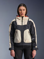 Alpinestars Molly Air Jacket, Women's Motorcycle Urban Jacket, Black Almond, front view on a model, featuring cream and black ripstop panels, hood with orange lining, front zipper closure, and large utility pockets, contemporary streetwear-inspired motorcycle gear