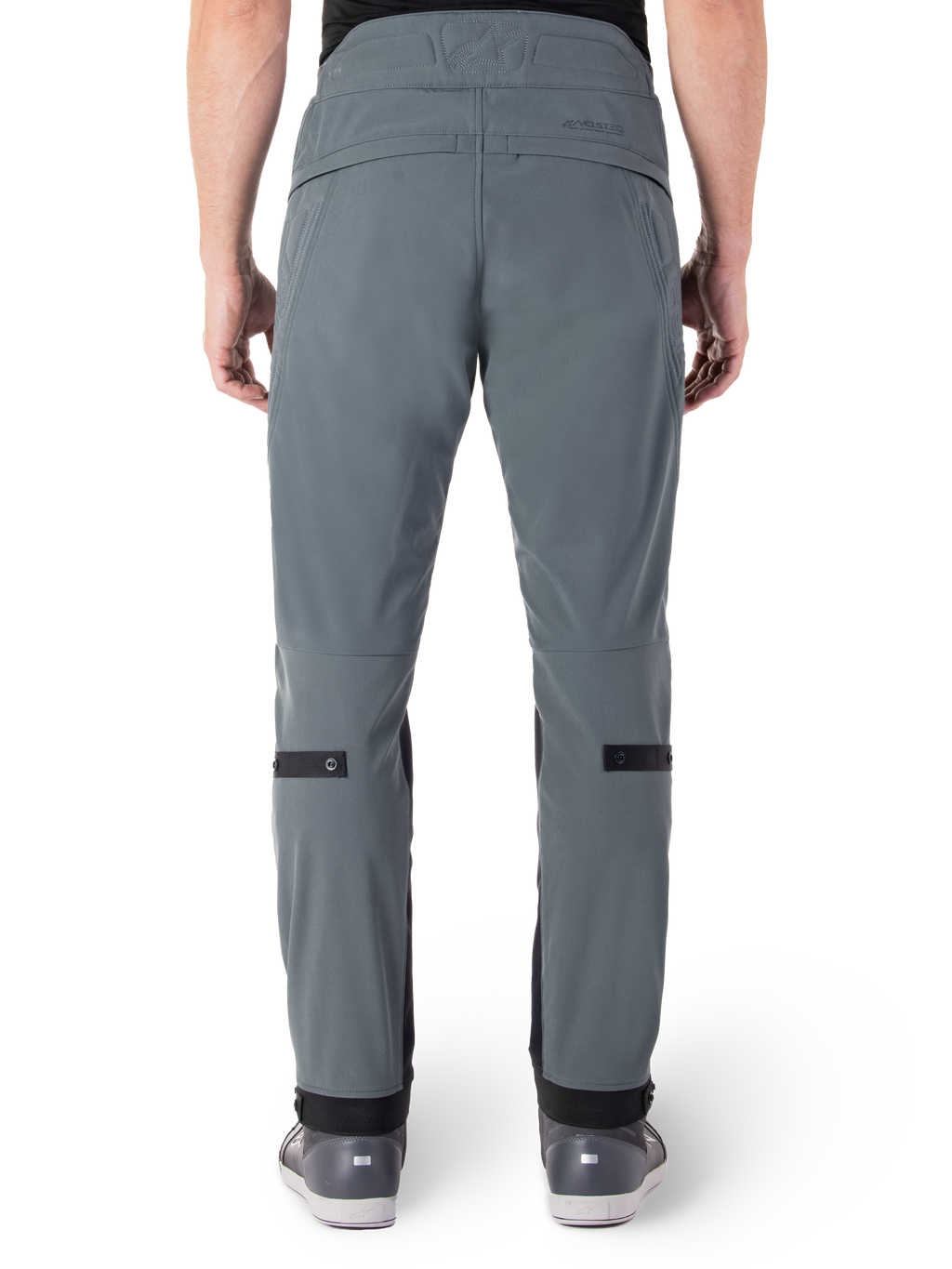 Alpinestars Alden Pants, Urban Gray, rear view of men's urban motorcycle pants, slim fit below the knee with black calf adjustment straps, high-waisted design featuring MO.ST.EQ. wordmark on the back yoke, worn with gray riding shoes