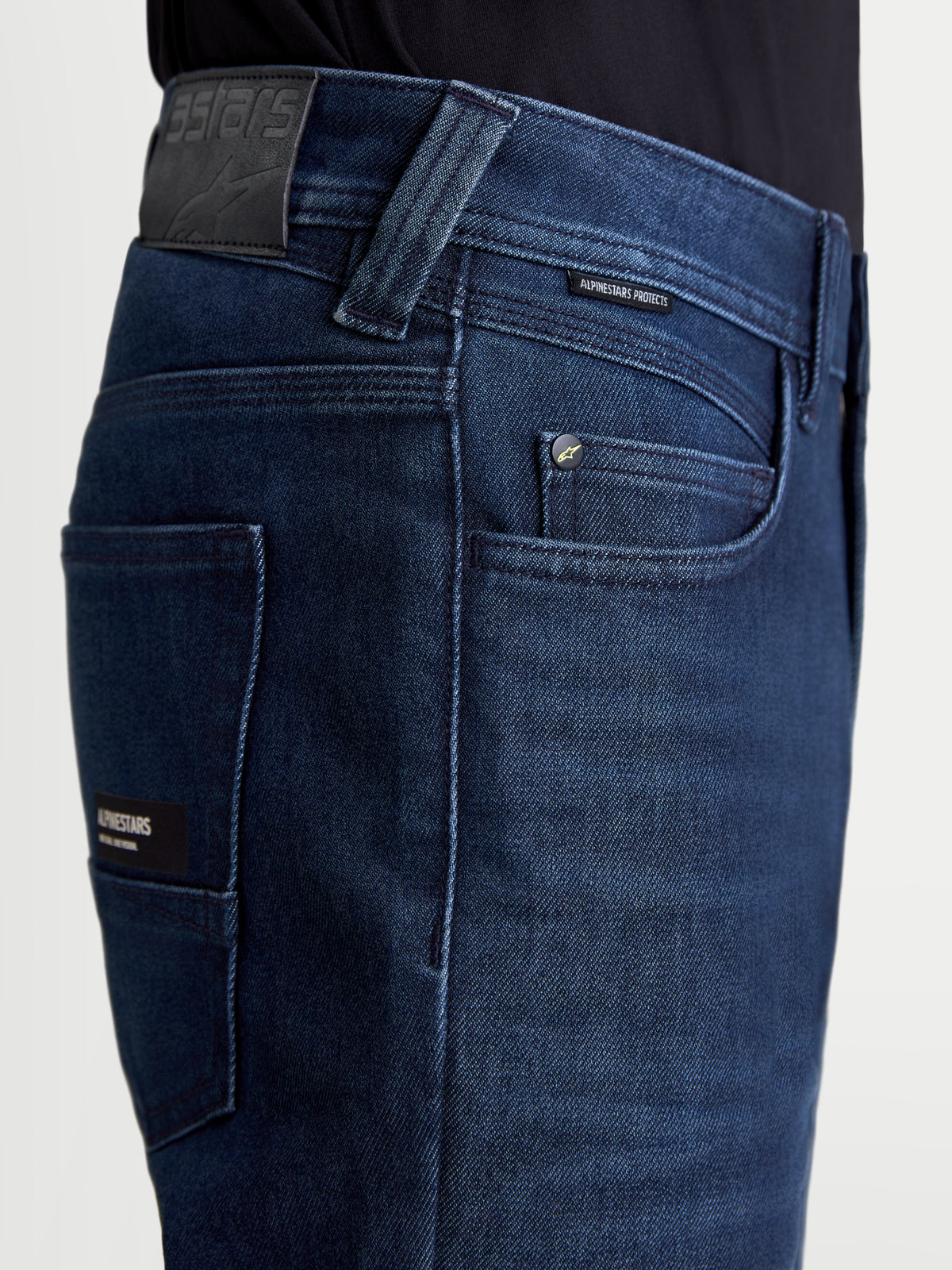 Alpinestars Flex-AST 10 Tough Max Denim Pants Short, urban motorcycle denim pants, dark blue, close-up view showing leather rear patch, coin pocket with Alpinestars Protects label, and AAA-rated single-layer denim construction